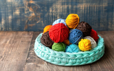 Multicolored balls of yarn in the knitted couch