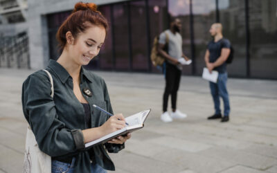 smiling-woman-writing-notepad